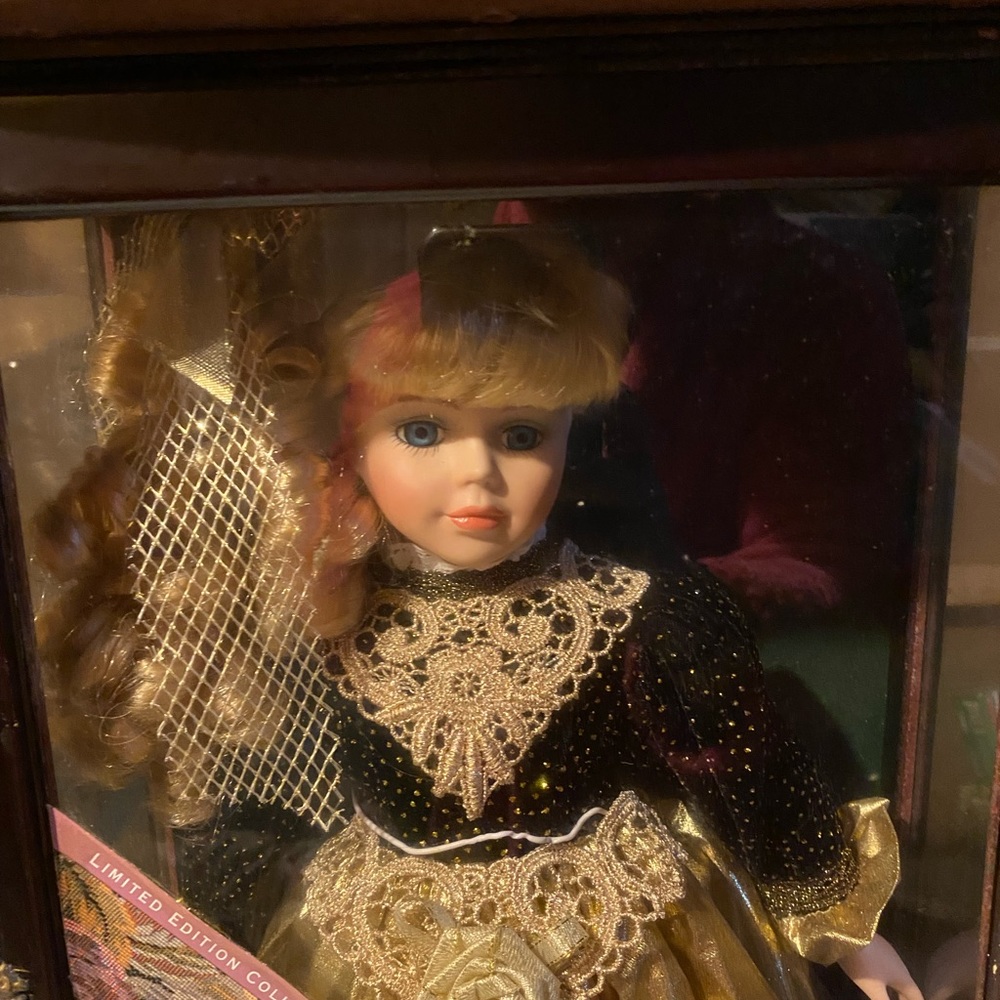 Used little ladies porcelain doll with display case